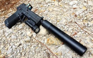 The Griffin Armament Revolution 45 ACP suppressor on the FNX Tactical with Trijicon RMR and Streamlight TLR-1