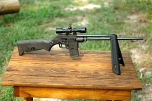 The KelTec SU16 takes AR15 magazines, I wouldn't take it to battle, but it's a great truck gun.