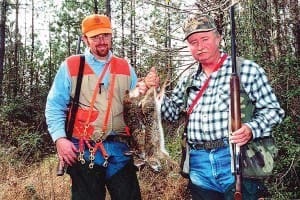 Enoch Drozda and J.W. Bolton compare rabbits they killed.