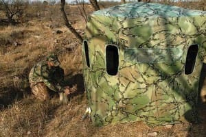 Shaine Nixon of World Slam Outfitters prepares a portable pop-up blind for hunting the mesquite country near Throckmorton.
