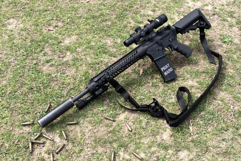 The well worn Trek suppressor on an Adams Arms .223 sporting a Trijicon Accupoint. 