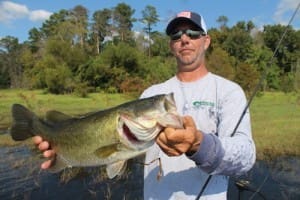 Russell Cecil holds a nice bass he caught by "punching" the hay.