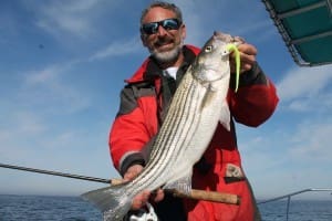 holding a striper in a float coat