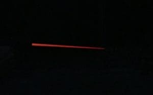 A 147 grain 9mm Streak Ammo streaking through the air at night towards the target.