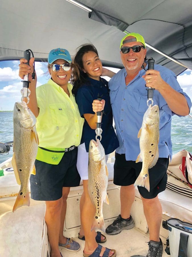 Mary and Chris Blood, with daughter Britney (center) caught their limit of reds, the largest a 10-pounder, in three hours on Lake Calaveras. Mary caught her first fish that day, despite grow-ing up on the Pacific Ocean where her dad was chef on a fishing boat!