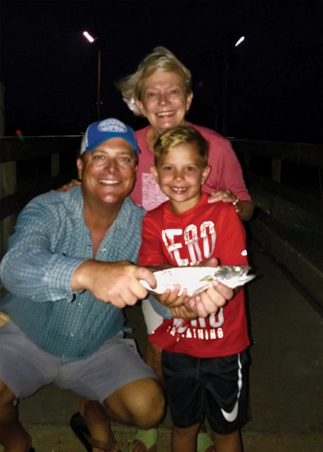 Anderson “Upgrade” Casey of Dallas shows off his first solo speckled trout, with proud Dad, Lee Casey, and excited Grandmother, “CiCi.”