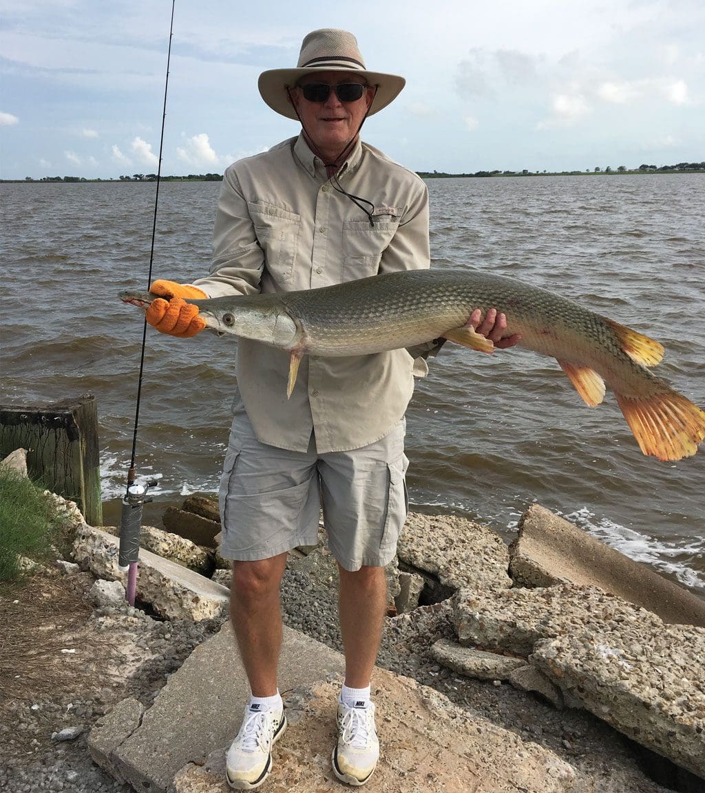 Bruce Smith caught this 50-inch alligator gar fishing in Carancahua, using cut bait. The giant gar was the biggest fish he has caught in the bay. He released it after winning the fight.