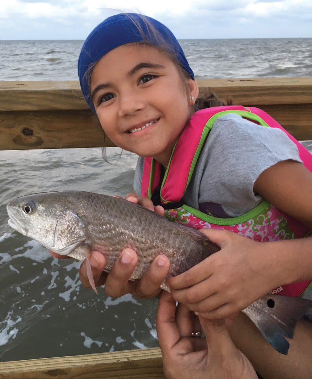 Seven-year-old Abryanna Rivera of Timberwood Park caught this 16-inch red on live shrimp while fishing from a pier on Aransas Bay.