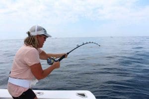 fighting a tuna with a belt on