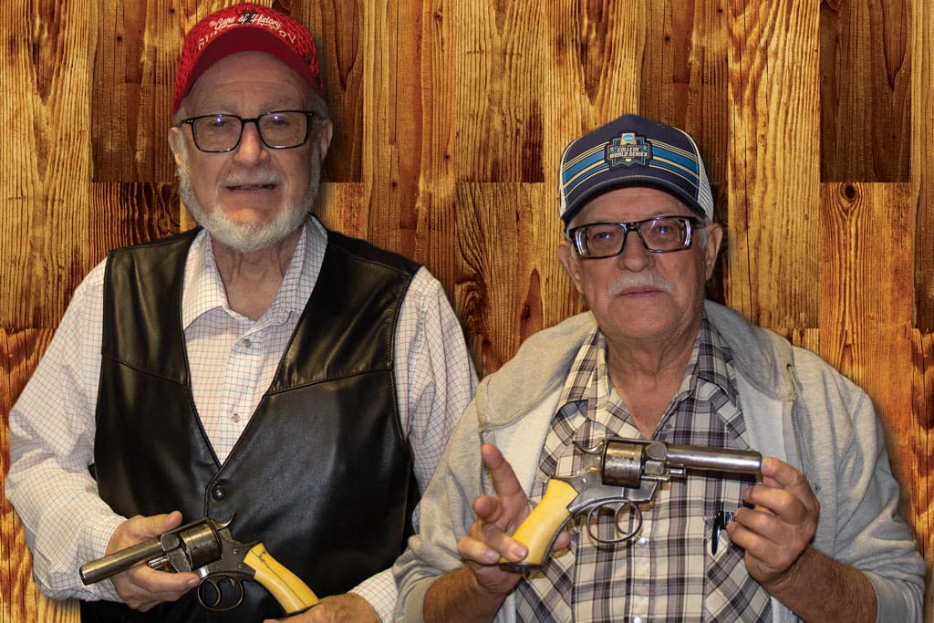 George Custer’s Webley revolvers are displayed by Wendell Grangaard (left) and another gentleman.