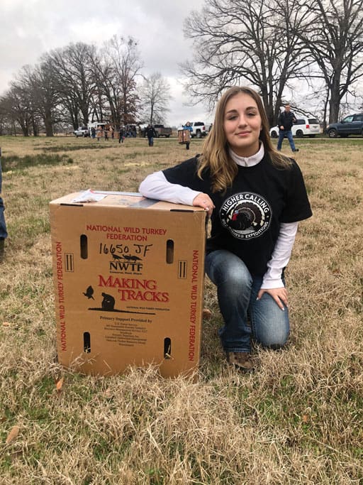 Emily Odom and a box containing an eastern turkey gobbler that was shipped from Missouri. TPWD is making big advances in restoring Eastern turkeys to the Pineywoods.