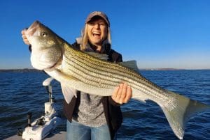 This happy Striper Express client shows off a Lake Texoma giant.