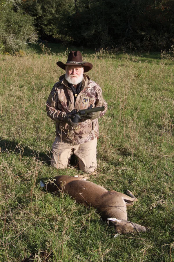 Larry with a doe he shot last fall with his Taurus handgun.