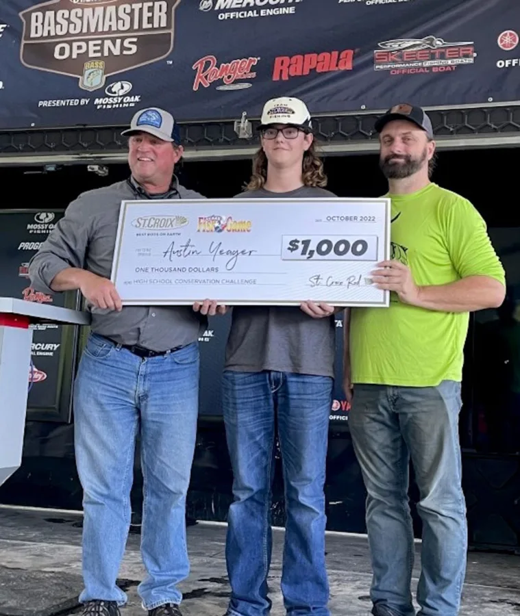 Jesse Simkins of St. Croix Rods, left, and Chester Moore of Texas Fish & Game award $1,000 scholarship to Conservation Challenge winner Austin Yeager.
