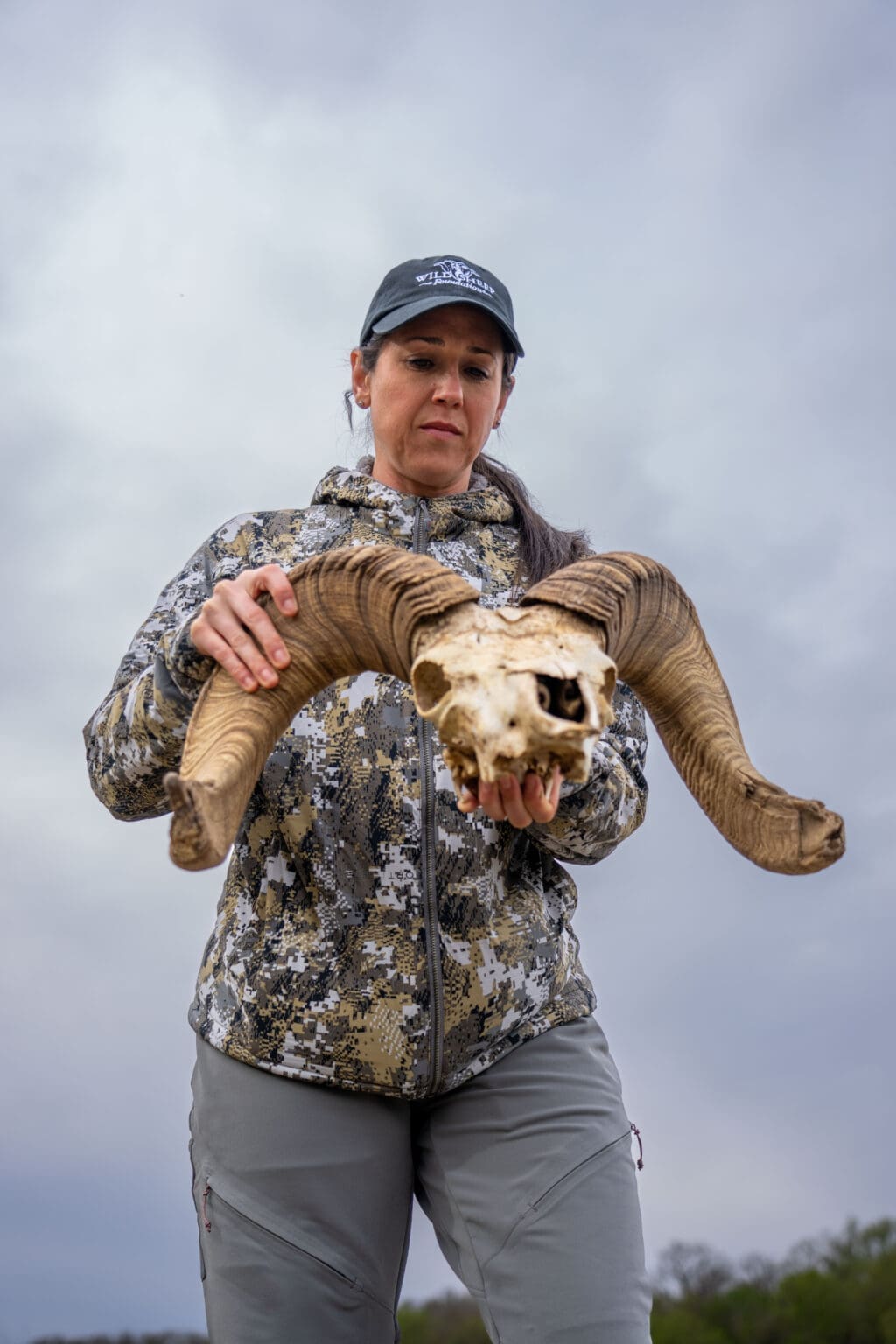Kat Hunter examines a Texas desert bighorn skull. Kat is a member of the Texas Bighorn Society, Wild Sheep Foundation and a 2022 graduate of Women Hunt.