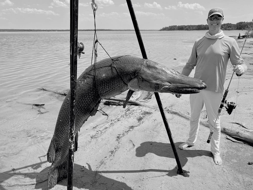 Art Weston, with his 283 pound alligator gar, caught on six pound line at Lake Sam Rayburn.