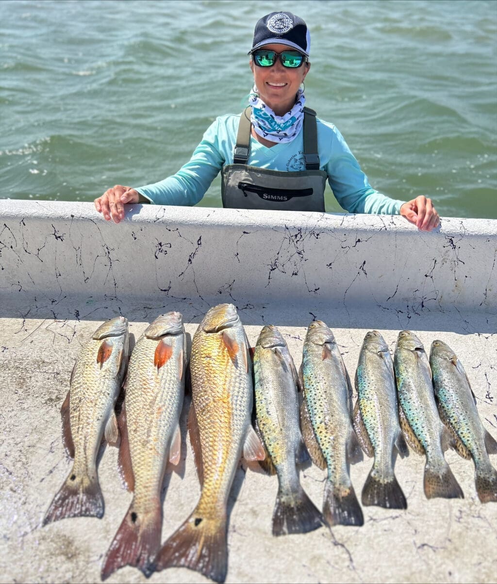 Krystal White of R&K Coastal Outfitters shows off a limit of Corpus Christi specks and reds.
