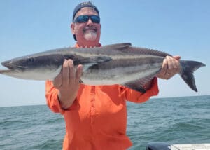 angler with a ling fish