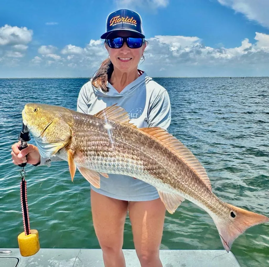 Krystal White of R&K Coastal Outfitters with a healthy bull red.