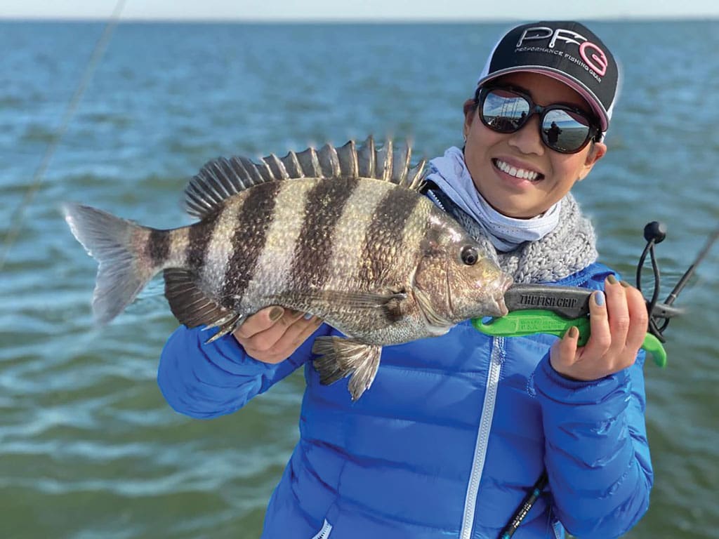 Cindy Nguyen (Columbia Fishing Athlete) with a nice sheepshead caught at the Galveston jetties while out fishing with Capt. Derek York of Spot Stalker Guide Service.