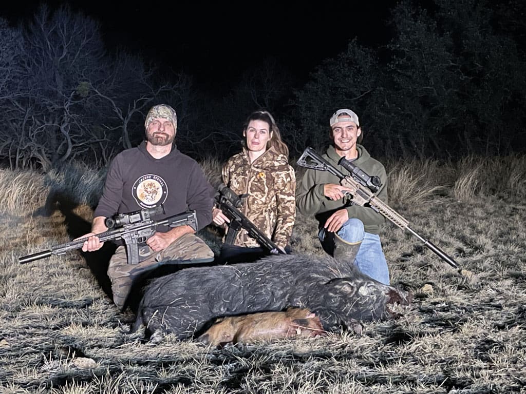 Thermal imaging optics helped TF&G Editor-In-Chief Chester Moore, Britt Perry and Andrew Austin bag these two hogs on the Warren Ranch.